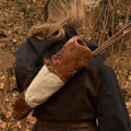 Hunter wearing the handwoven leather back quiver with arrows in a wooded setting