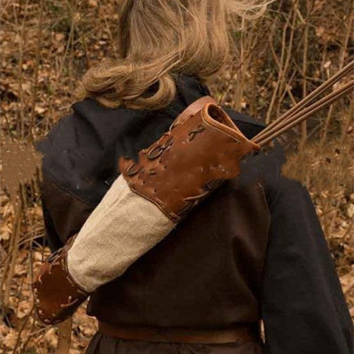 Hunter wearing the handwoven leather back quiver with arrows in a wooded setting