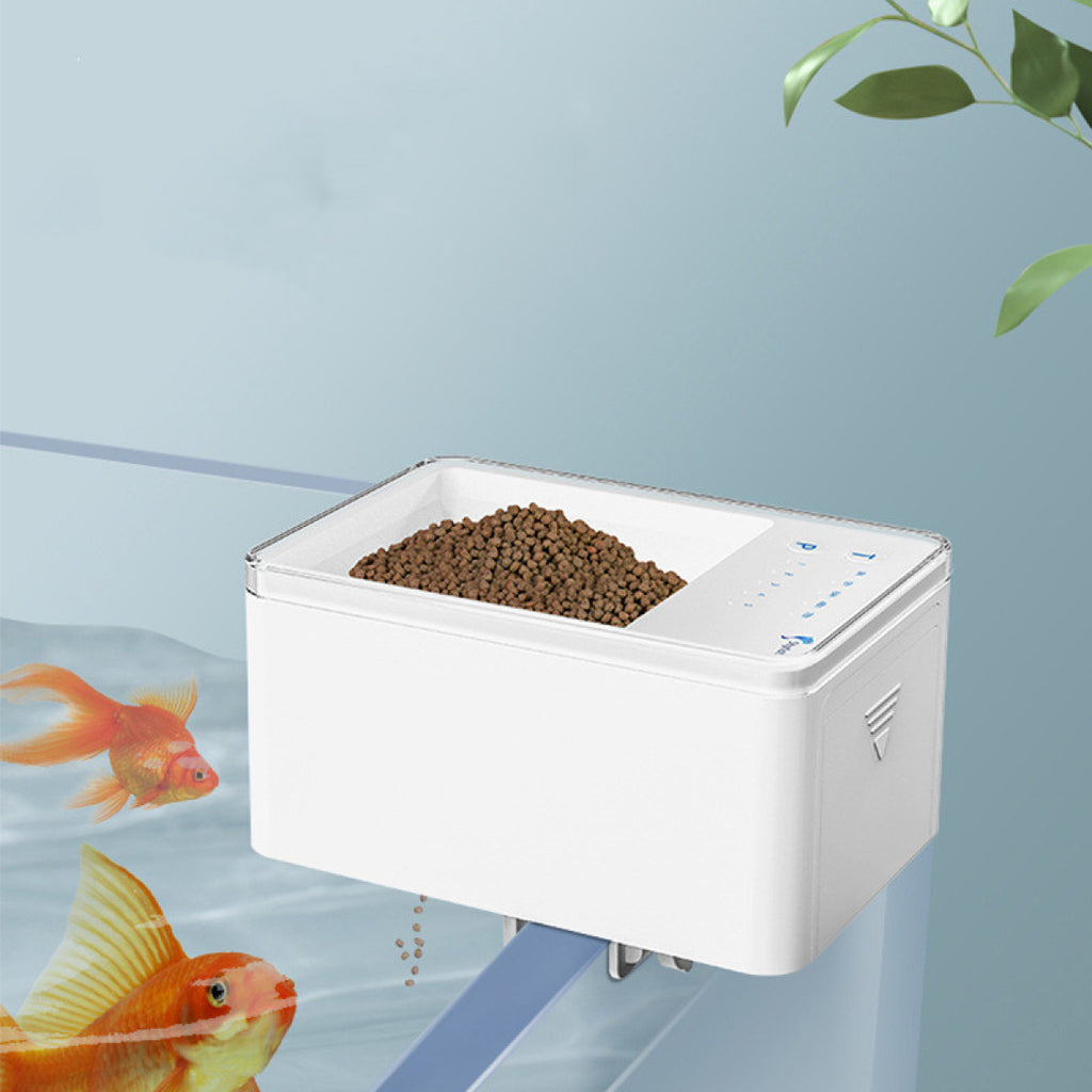 Automatic fish feeder dispensing food pellets into aquarium