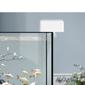 Automatic digital fish feeder mounted on aquarium with goldfish