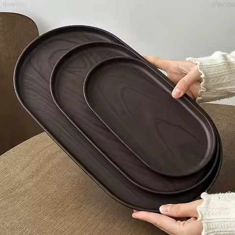 Oval wood tray styled on coffee table
